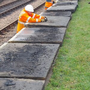 Scraping tarmac from the flagstones